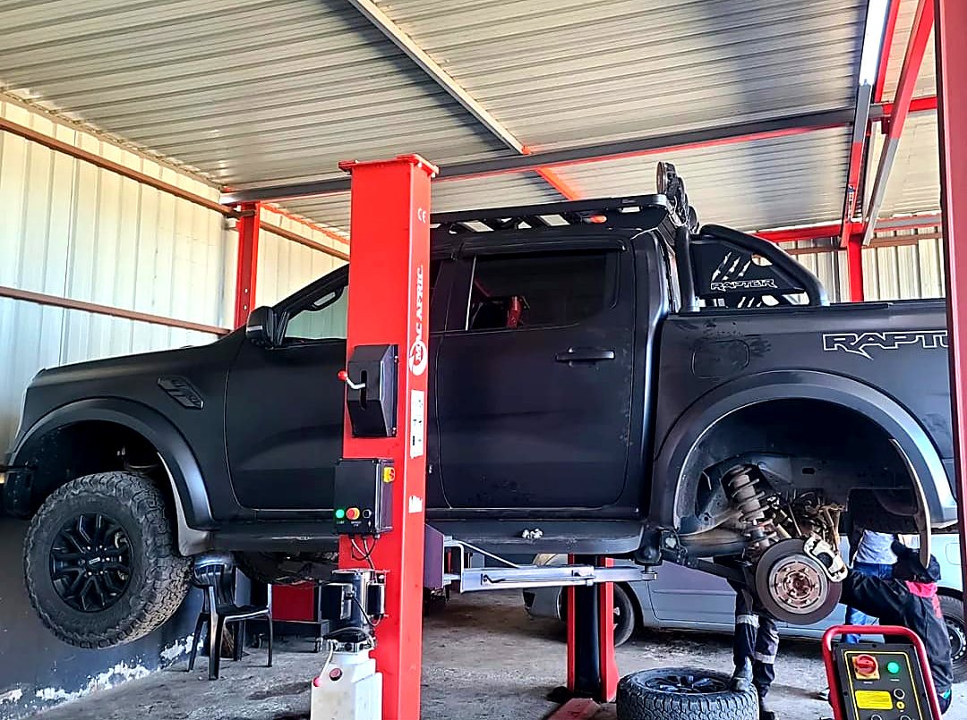 Ford Ranger Raptor raised on a lift for suspension and brake work at Mecca Auto & General