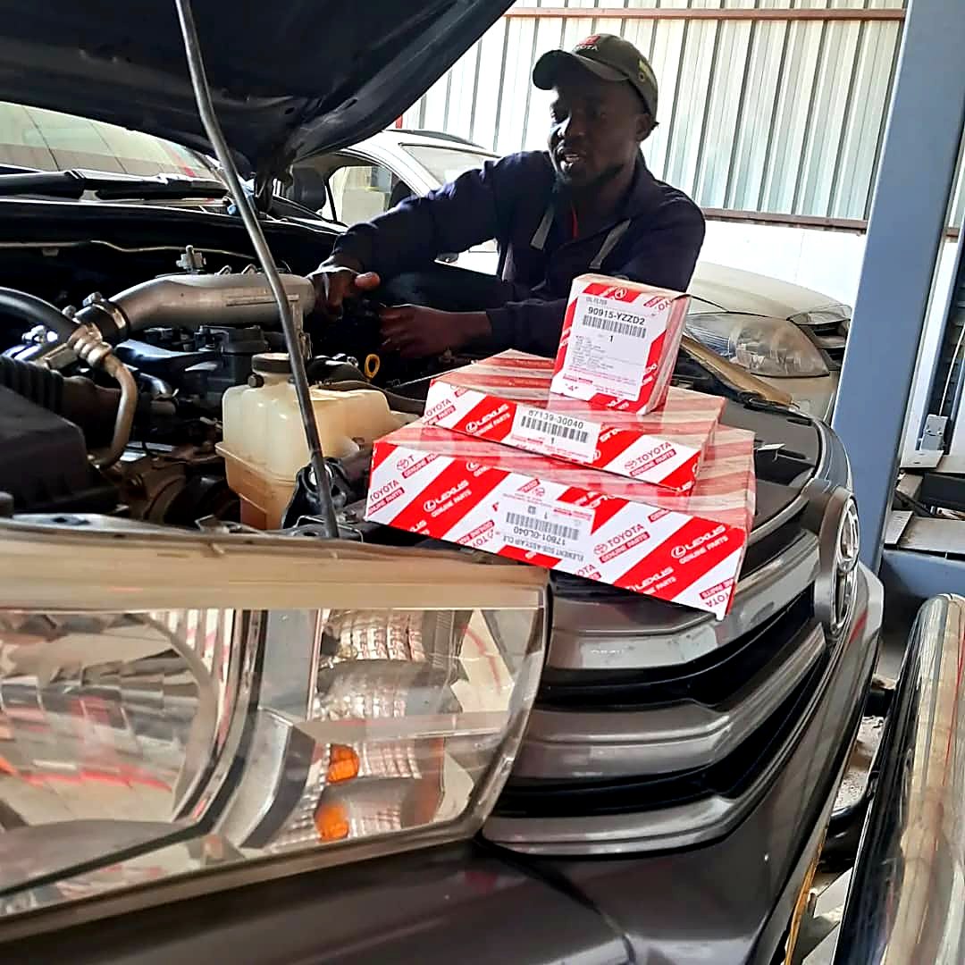 Mecca technician servicing a Toyota with genuine Toyota filters and parts